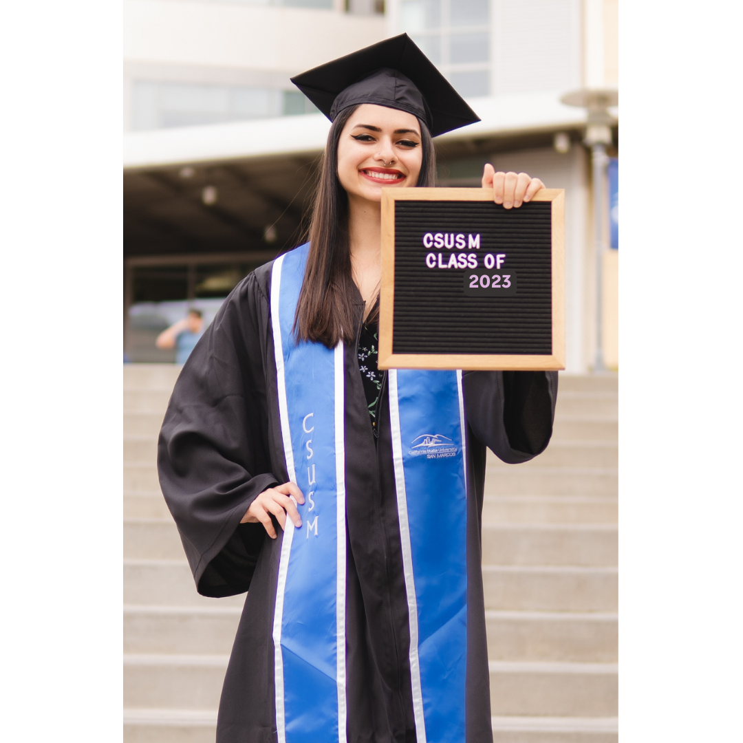 Graduation photo of CSUSM student with letterboard.