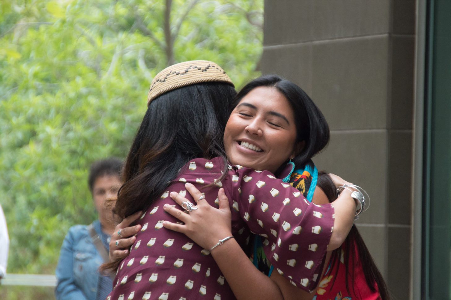 tribal student hugging tribal services staff at graduation celebration